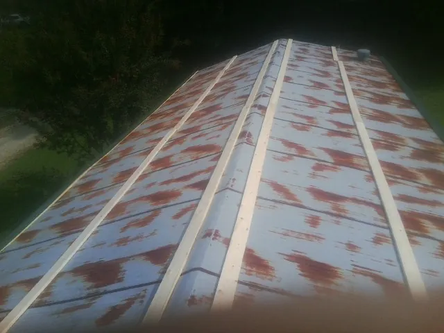 Rusted metal roof panels with new wood purlins before replacement — Storm Damage Roof Repair in Shepherdsville by Roofing Brothers