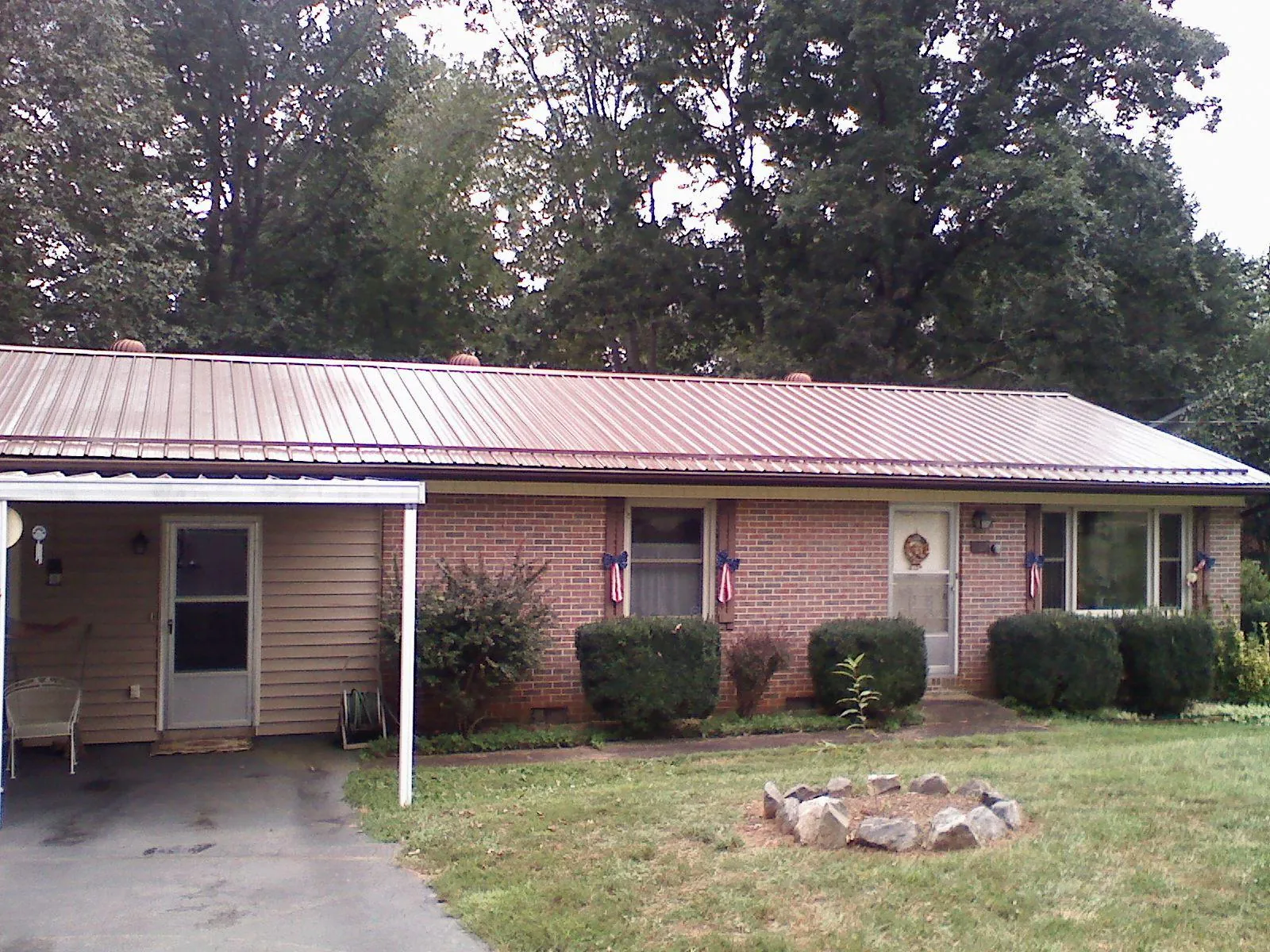 Bronze metal roof and carport on a brick ranch home — Roof Repair work by our crew in Shepherdsville