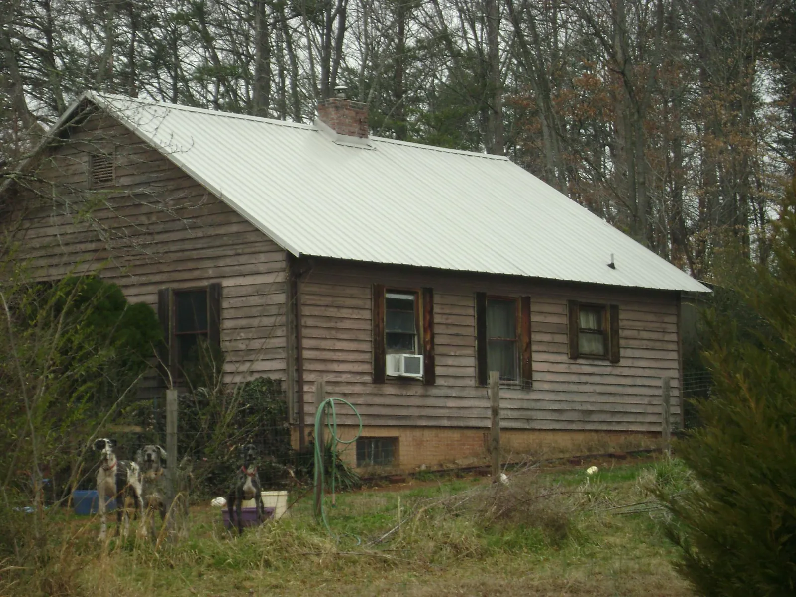 White metal roof on an old wood sided farmhouse, from a Metal Roof Installation job in Shepherdsville